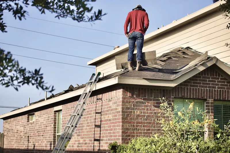 Professional roofer working on a residential roof in North Albany